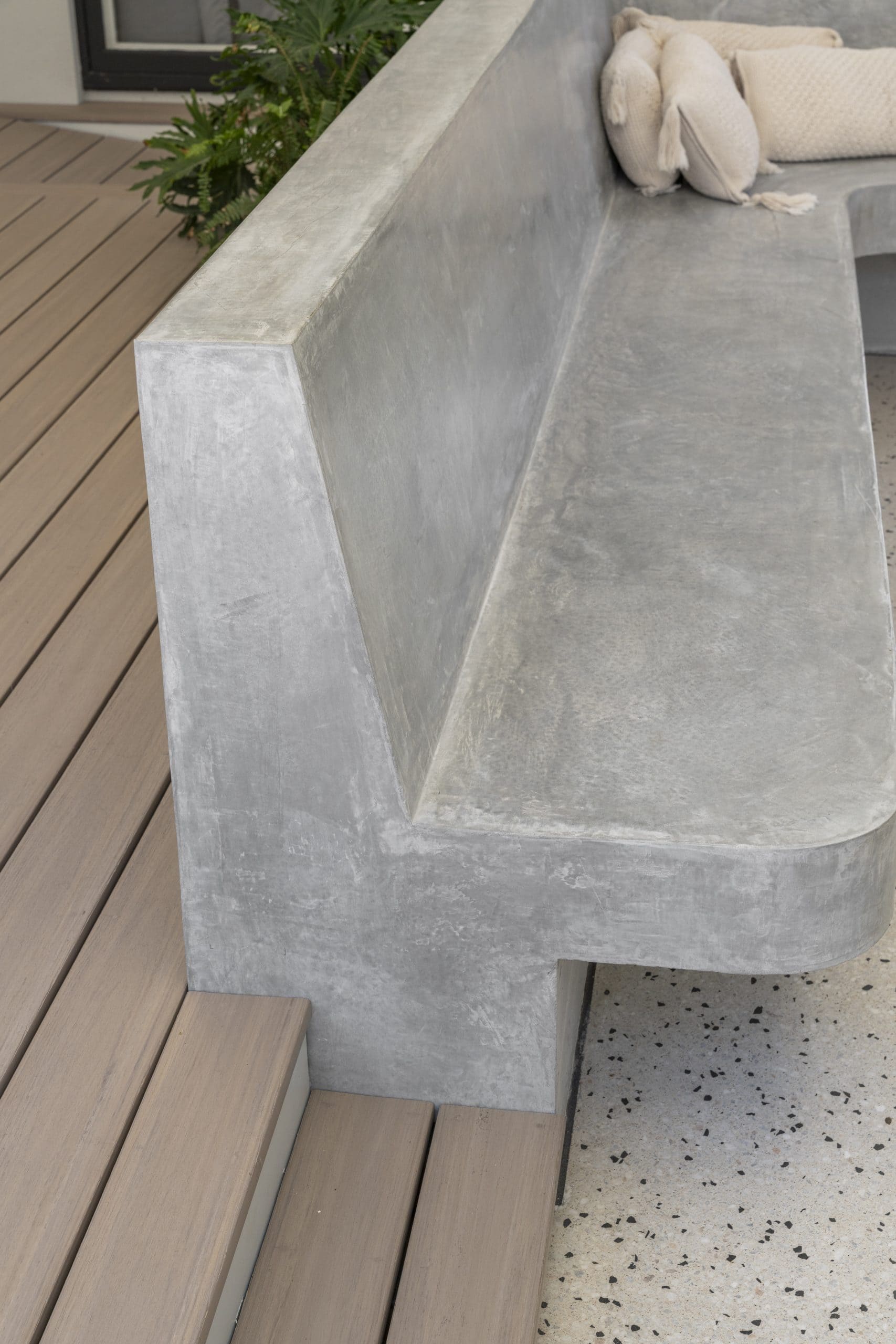 Custom titanium honed concrete seating detail in outdoor entertaining space at a Glengowrie home