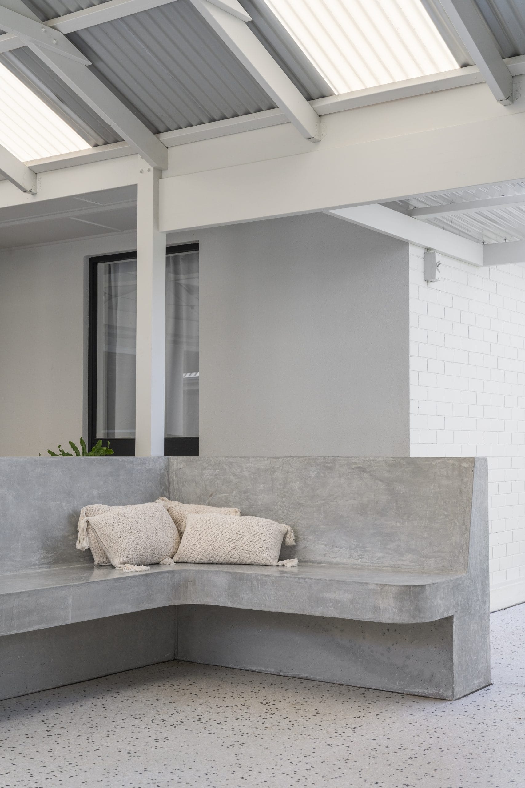 Hand-finished concrete seating feature in family-friendly outdoor renovation in Glengowrie